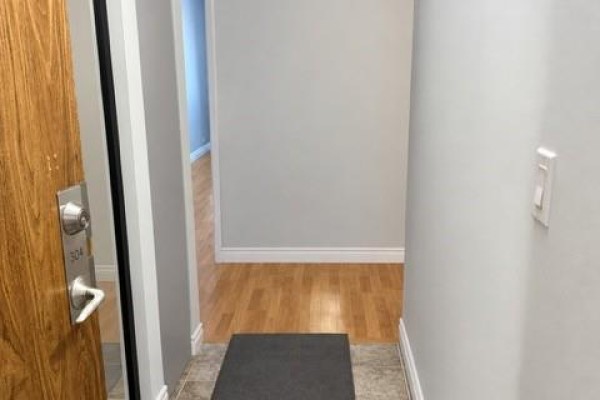 Building entrance with glass doors, tile floor, and textured wallpaper. - 3355 Sandwich Street Unit# 304, Windsor
