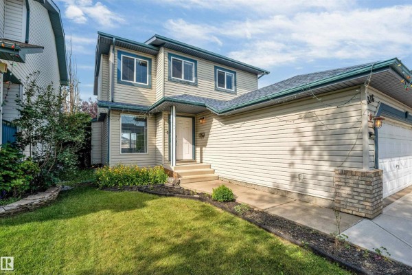 Aerial view of suburban houses with garages, driveways, and backyards. - 336 Wild Rose Wy Nw, Edmonton