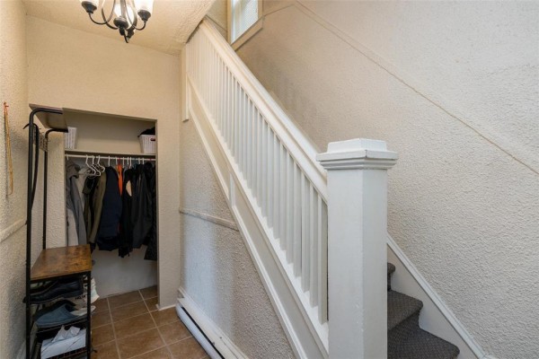Interior entryway with a staircase, coat rack, and tiled floor. - 337 Bannerman Avenue, Winnipeg