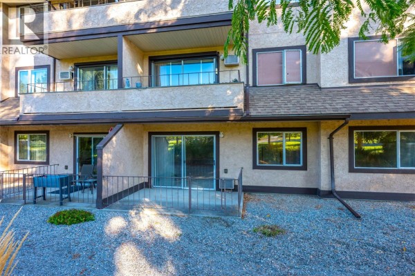 Exterior view of ground floor apartments with sliding doors, patios, and windows. - 337 Mckinney Road Unit# 107, Oliver