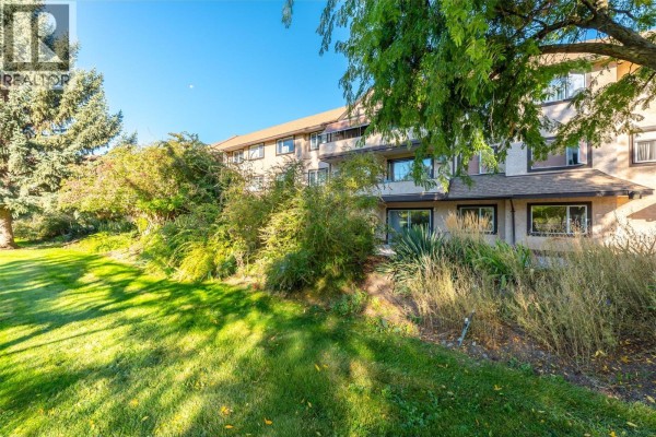 Exterior view of apartment building with grass, trees, and foliage. - 337 Mckinney Road Unit# 107, Oliver