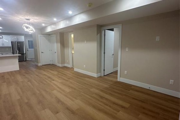 Open concept living area with wood-look vinyl flooring and white doors. - 3371 Byng Unit# 2, Windsor