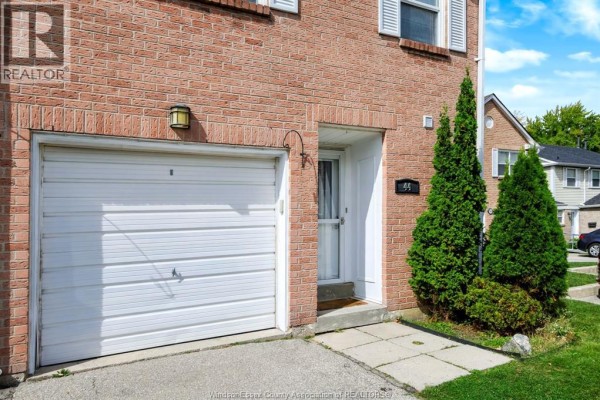 Interior hallway view showing a staircase, double closet doors, and an open doorway to another room. - 3380 South Millway Unit# 44, Mississauga