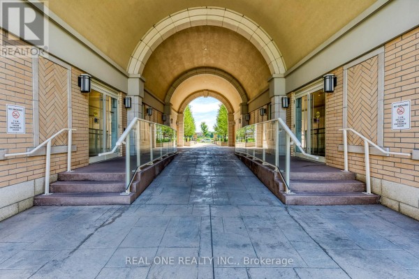 Covered walkway with ramp and stairs leading into building with glass doors. - 339 - 28 Prince Regent Street, Markham