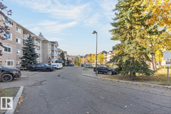Asphalt road leading into the Carrington West apartment complex parking area. - #339 17447 98a Av Nw, Edmonton