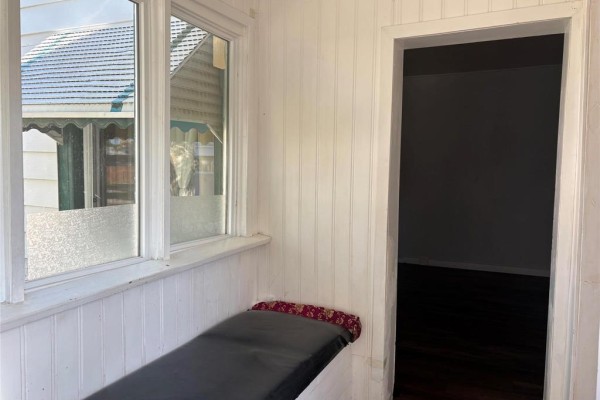 Interior view of a window seat with a dark cushion and wood flooring. - 339 Union Avenue, Winnipeg