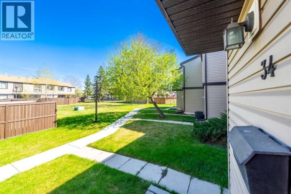 Modern kitchen with stainless steel appliances and light wood cabinetry - 34, 3029 Rundleson Road Ne, Calgary