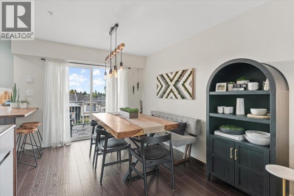 Dining area with a live-edge wood table, black chairs, and a dark arch bookcase. - 34 7370 Stride Avenue, Burnaby