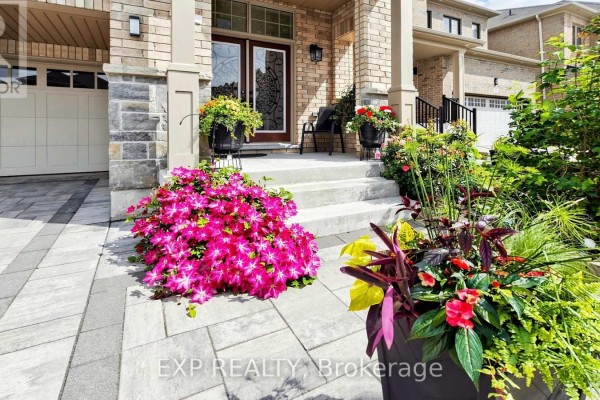 Close-up of the entrance stairs and walkway of a brick house with colorful flowers. - 34 Buttonleaf Crescent, Whitchurch Stouffville