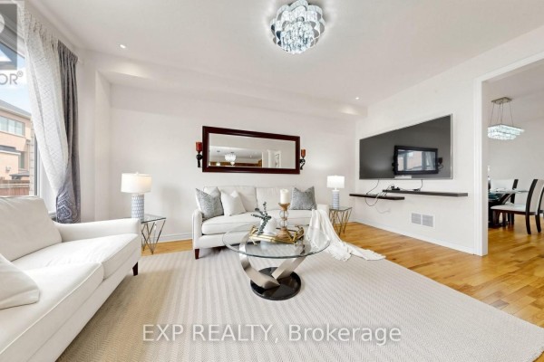 Living room with white sofas, glass coffee table, TV, and chandelier - 34 Buttonleaf Crescent Whitchurch Stouffville