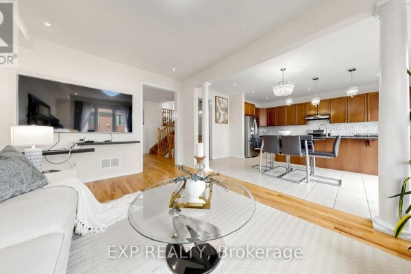 Open concept living room and kitchen with TV, sofa, and breakfast bar - 34 Buttonleaf Crescent Whitchurch Stouffville