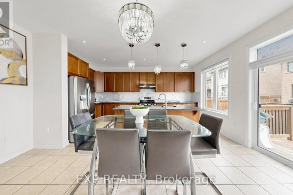 Glass dining table in kitchen with wooden cabinets and deck access - 34 Buttonleaf Crescent Whitchurch Stouffville