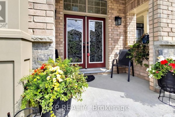 Front door with glass panels and a seating area on the covered porch. - 34 Buttonleaf Crescent, Whitchurch Stouffville