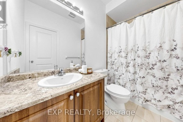 Bathroom with floral shower curtain, granite vanity, and wooden cabinets - 34 Buttonleaf Crescent Whitchurch Stouffville