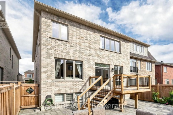 Backyard with wooden deck and patio - 34 Buttonleaf Crescent Whitchurch Stouffville