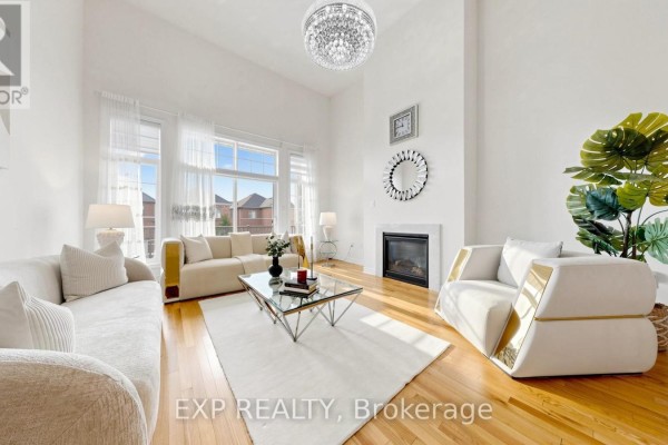 Living room featuring two sofas, armchairs, a glass coffee table, and a chandelier. - 34 Buttonleaf Crescent, Whitchurch Stouffville
