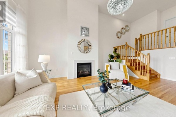 Living room with fireplace, hardwood floors, and chandelier - 34 Buttonleaf Crescent Whitchurch Stouffville