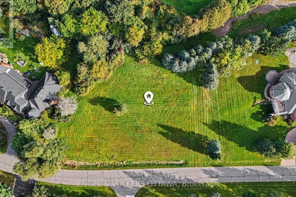 Direct overhead view of a sunlit, grassy lot with trees and a map pin icon. - 34 Cedarhill Drive, Ottawa