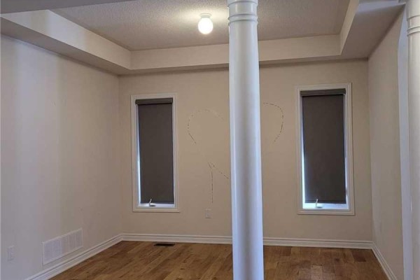 Room with light beige walls, two windows with grey blinds, and hardwood floors. - 34 Furniss Street, Brock