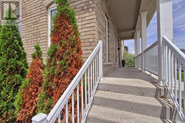 Concrete stairs with white railing leading up to a covered porch. - 34 Grey Wing Avenue, Georgina