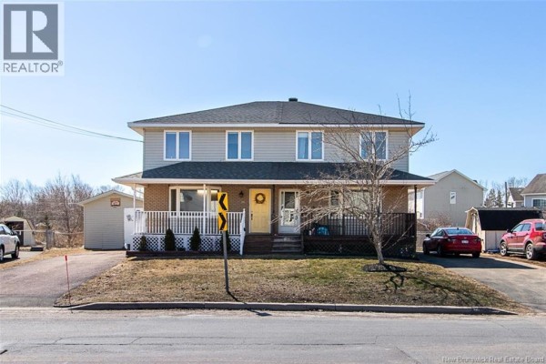 Exterior view of the house from the street with a driveway and shed. - 34 Rennick Road, Moncton