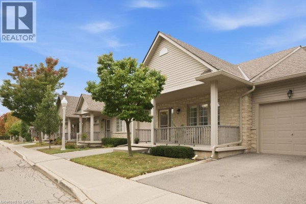 Side view of townhouse units with covered porches and garages. - 34 Southbrook Drive Unit# 7, Binbrook