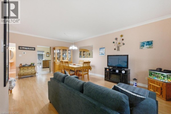 Living and dining area with hardwood floors and neutral walls. - 34 Southbrook Drive Unit# 7, Binbrook