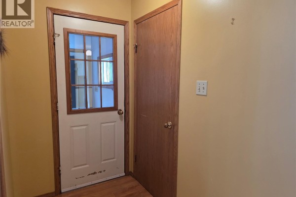 Close-up view of a pink vanity sink and a white toilet in a room with tan walls. - 34 Stanley Street, Creelman