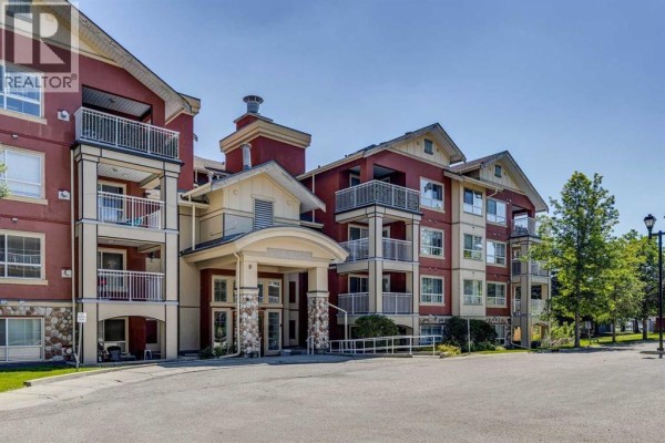 Front exterior of a red and cream building with balconies and stone accents. - 340, 22 Richard Place Sw, Calgary