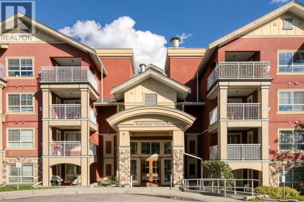 Close-up of the main entrance of "Trafalgar House" building with stone pillars and balconies. - 340, 22 Richard Place Sw, Calgary