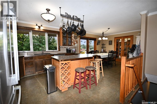 Kitchen with stainless steel appliances, wood cabinetry, island, and a view of the dining area. - 340 Johnson Avenue, Big River