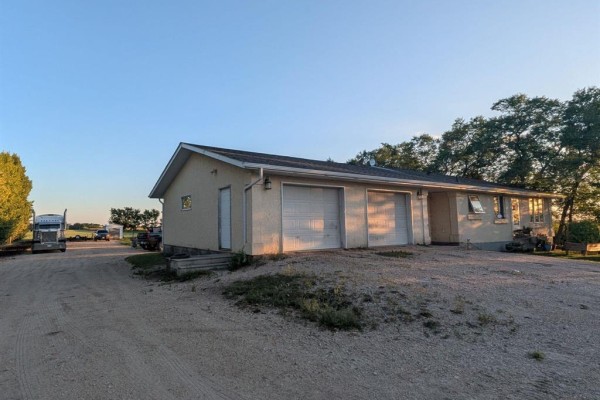 Interior hallway with beige tile floors, white walls, and a glass-paneled front door. - 34088 41n Road, Blumenort