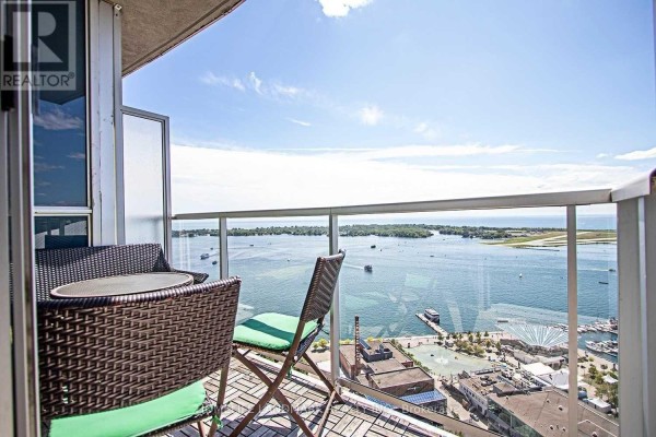 Aerial view of a waterfront area with buildings, parks, and boats in the harbor. - 3409 - 208 Queens Quay W, Toronto
