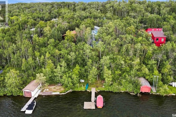 Aerial view of the property from above showing multiple structures, docks, boats, and the shoreline of Wakaw Lake. - 3409 East Nickorick Beach, Wakaw Lake