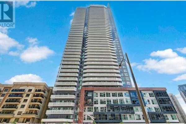 A tall condominium building with many balconies against a bright blue sky with clouds. - 3410 - 4065 Confederation Parkway, Mississauga