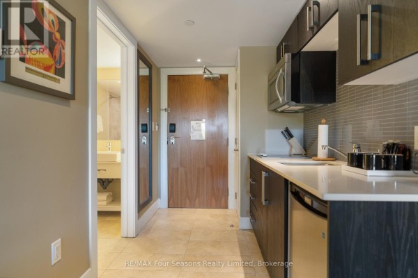 Kitchenette with modern appliances, cabinetry, and entry door - 3411/3413 - 9 Harbour Street E, Collingwood
