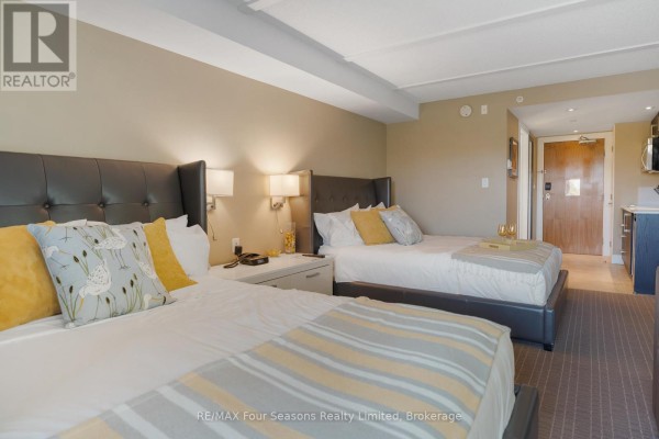 Guest room with two queen beds, decorative pillows, and neutral color scheme - 3411/3413 - 9 Harbour Street E, Collingwood