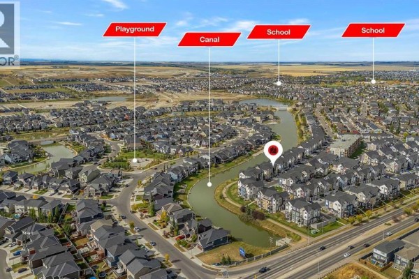 First floor plan of 342 Canals SW townhouse showing kitchen, dining, living, and balcony. - 342 Canals Crossing  Sw, Airdrie