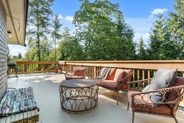 Exterior view of a single-story house with a long driveway and carport. - 34251 George Ferguson Way, Abbotsford