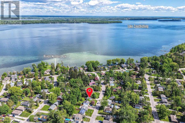 Aerial view of a neighborhood with Lake Couchiching in the background. - 3427 Coronation Avenue, Severn