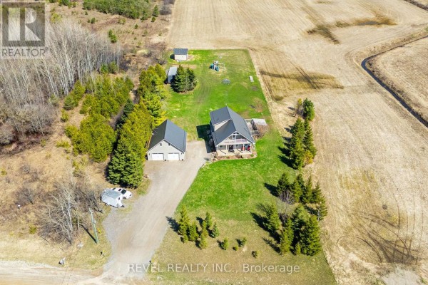 Overhead view of the house, garage, and adjacent outbuildings on a large property. - 343071 Side Road 15 Side Road, Amaranth