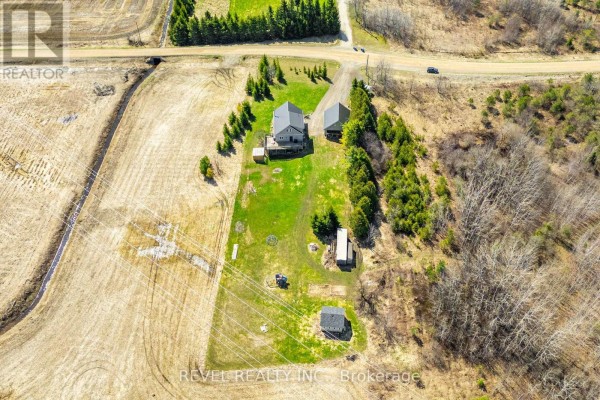 Aerial view showing the property's buildings, fields, and surrounding rural landscape. - 343071 Side Road 15 Side Road, Amaranth