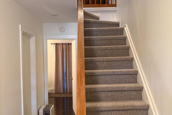 Hallway with a carpeted staircase and a doorway to another room. - 345 - 11 Harbour Street W, Collingwood