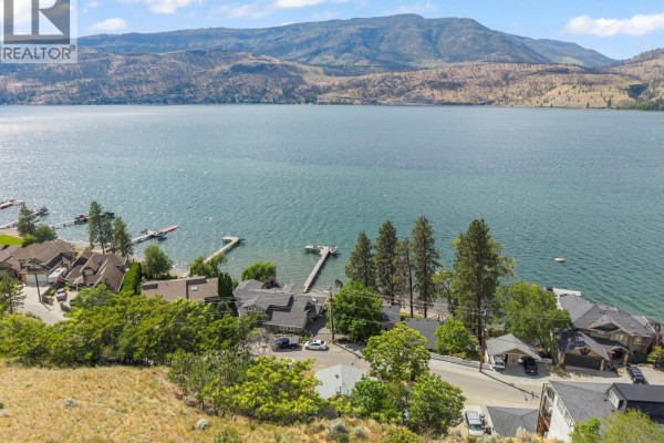 Aerial view of houses and docks on the shore of a large lake. - 345 Poplar Point Drive, Kelowna