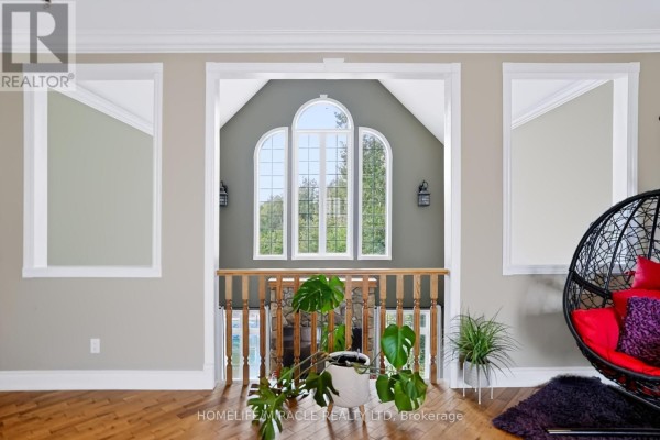 Arched windows and hanging chair in hallway - 345305 15th Side Road Amaranth