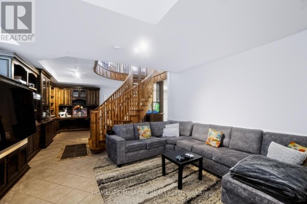 Living room with sectional sofa and spiral staircase - 345305 15th Side Road Amaranth