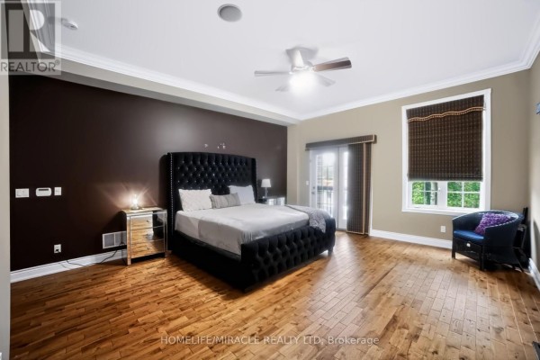 Tufted king bed & hardwood floors in bedroom - 345305 15th Side Road Amaranth