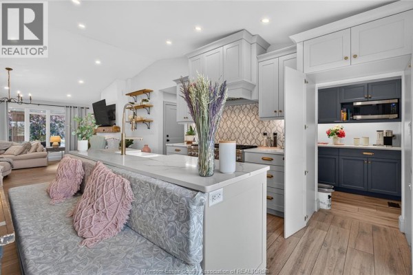 Modern kitchen with island, bench seating, and pantry - 346 Texas Road Amherstburg