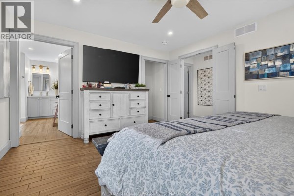 Bedroom with TV, ceiling fan, and en-suite bathroom access - 346 Texas Road Amherstburg