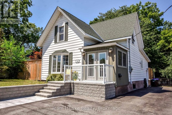Front view of white sided house with new stone steps. - 346 Yonge Street, Midland